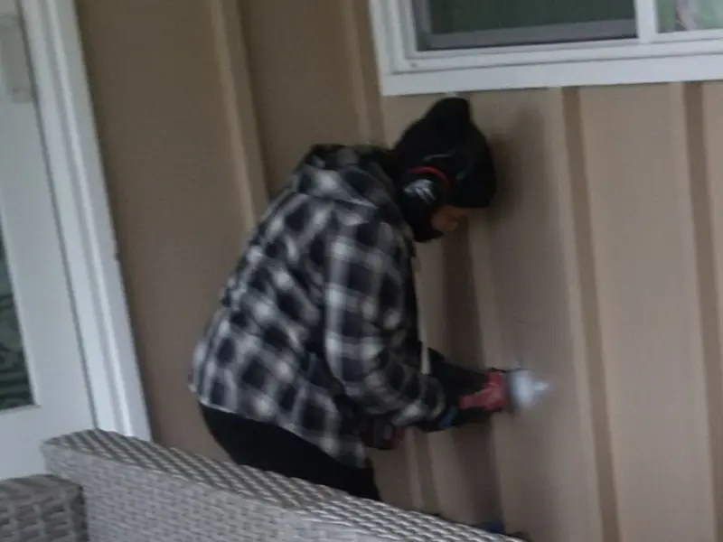 Professional electrician installing an exterior outlet in Spring Valley